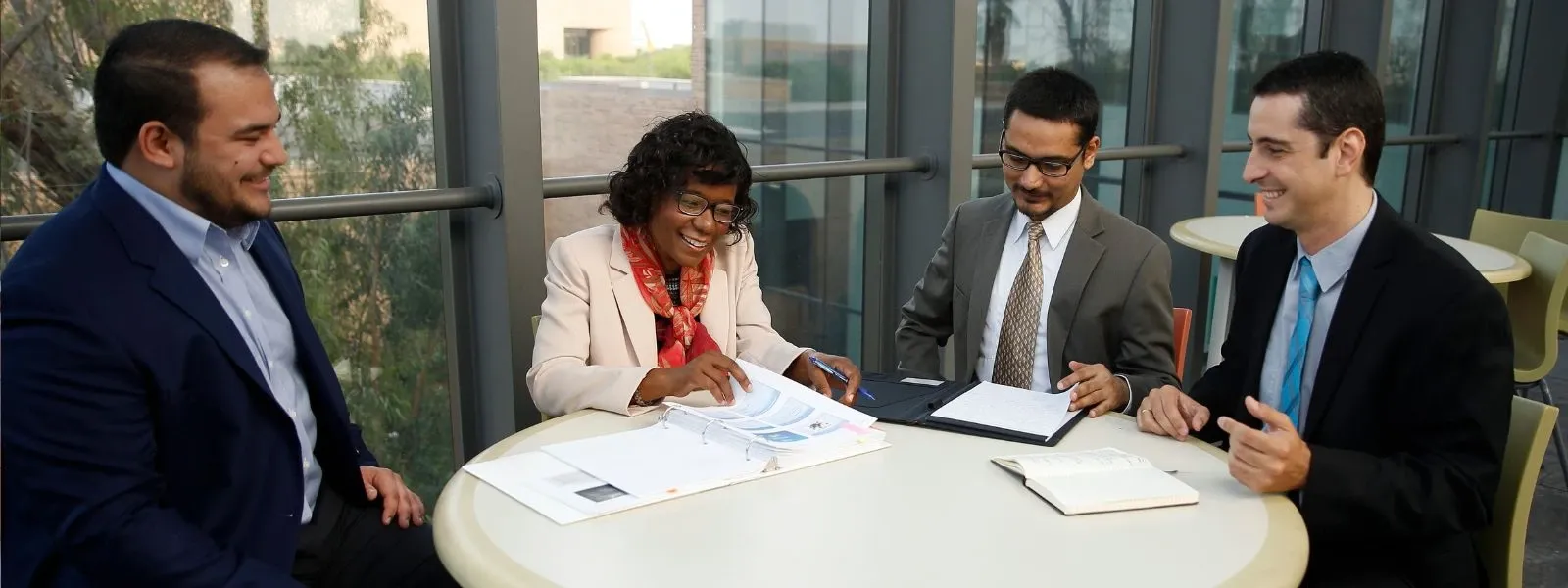 Business graduate students reviewing business documents